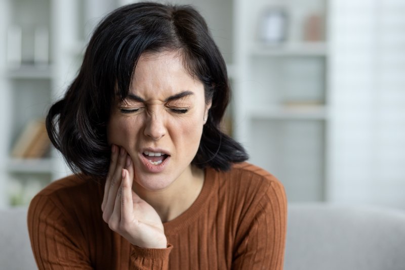 woman experiencing intense tooth pain